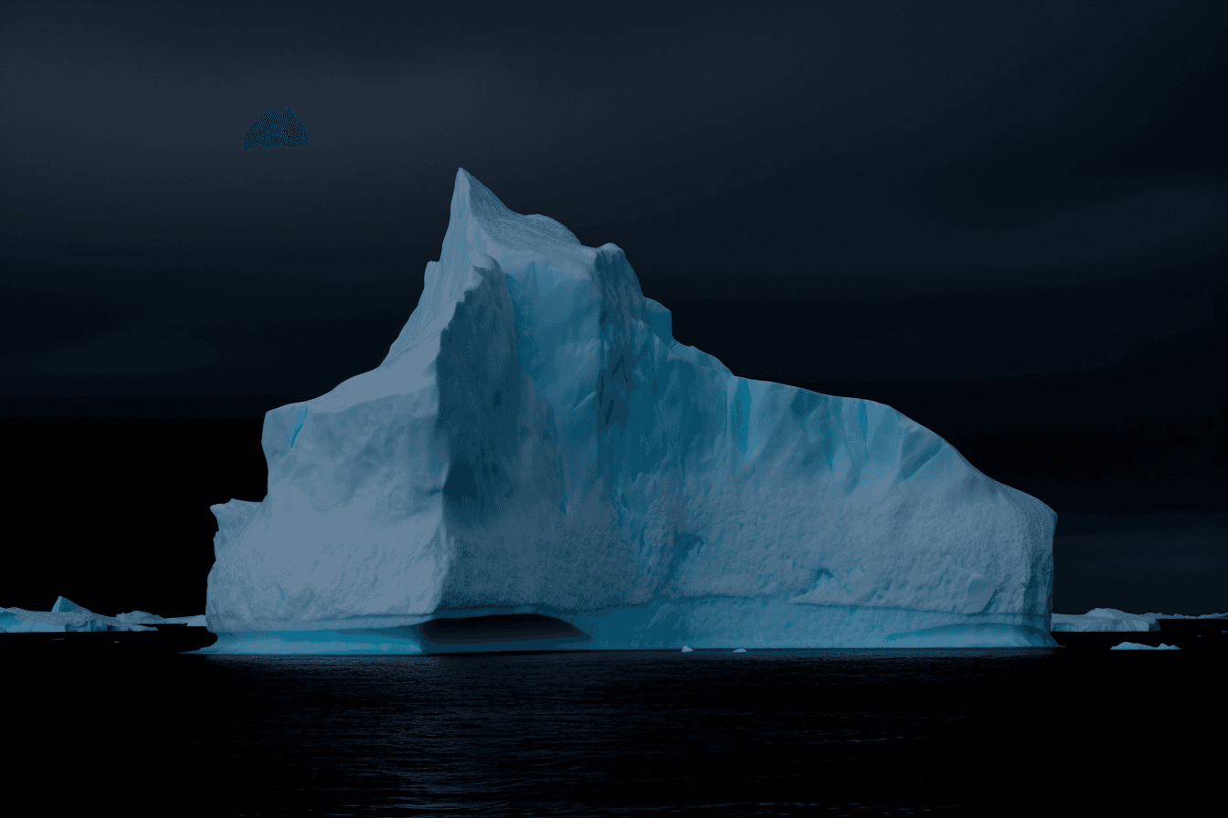 A photograph of an iceberg in the Arctic, with the blue and white colors contrasting against a dark sky.