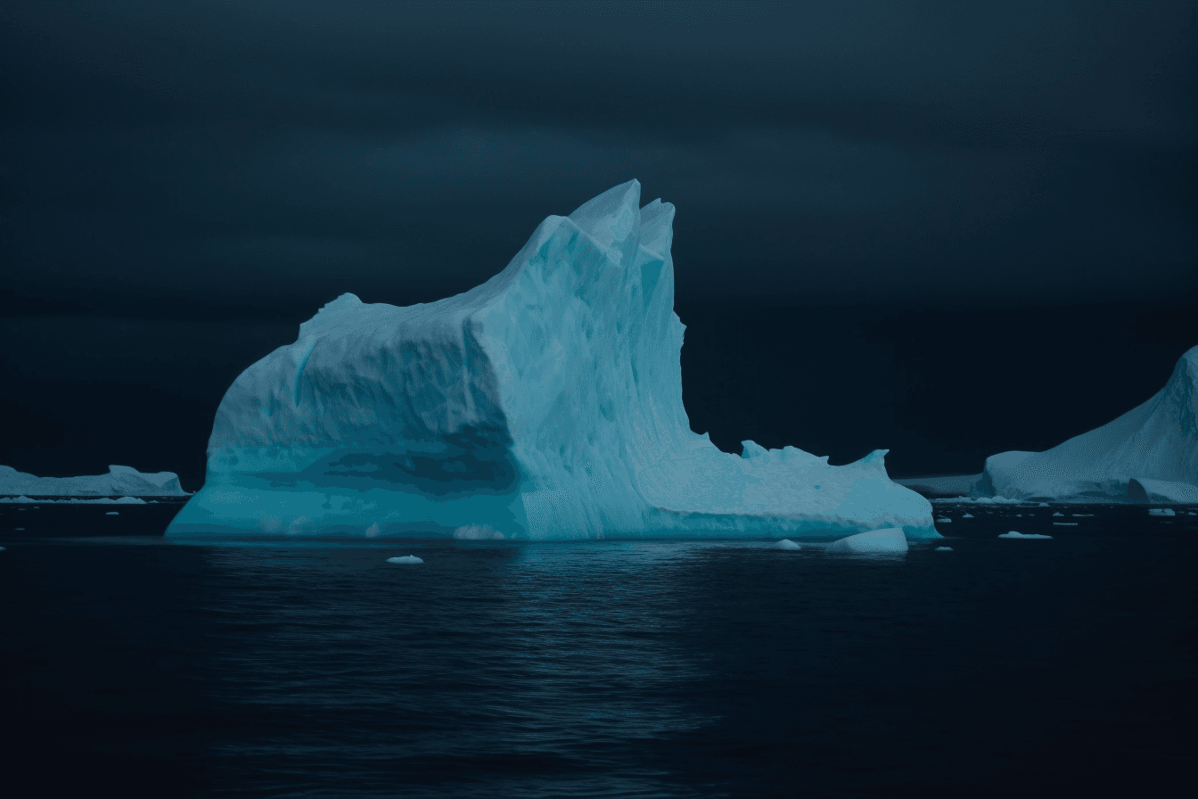 A photograph of an iceberg in the Arctic, with the blue and white colors contrasting against a dark sky.